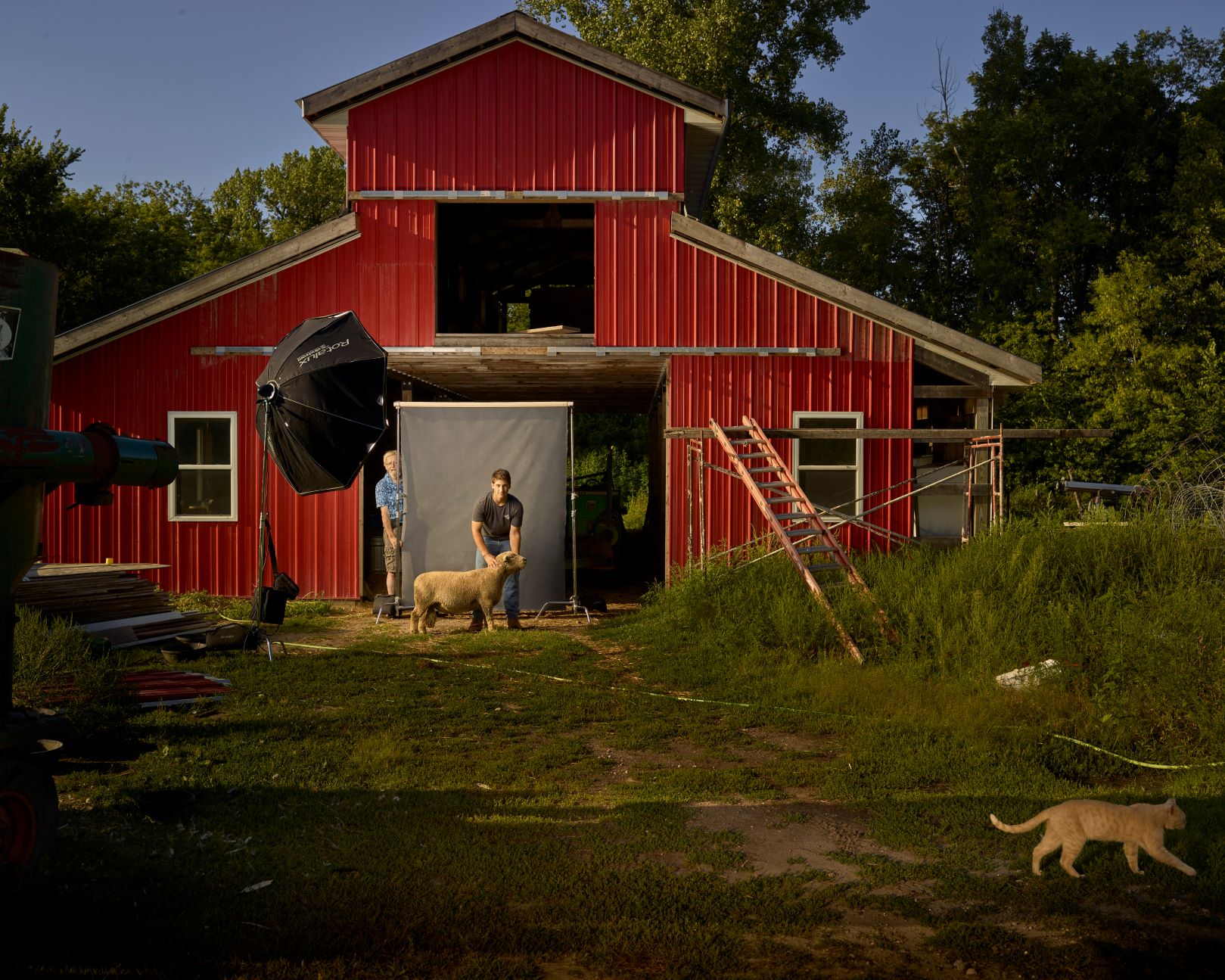 R. J. Kern Person poses with animal near barn.
